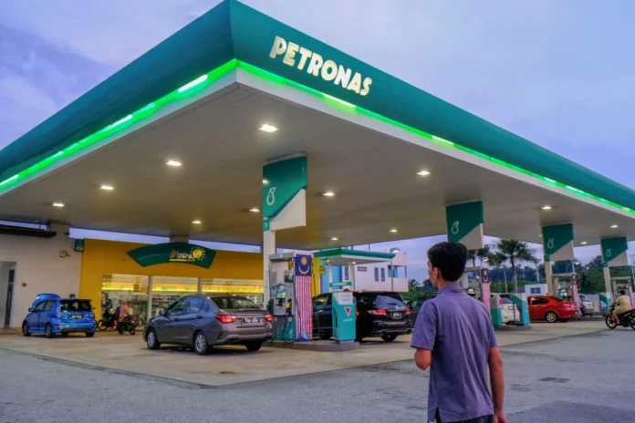 A man enters a Petronas petrol station in Kuala Lumpur. Malaysia has launched a new targeted fuel subsidy scheme limiting discounted purchases to 300 litres a month.