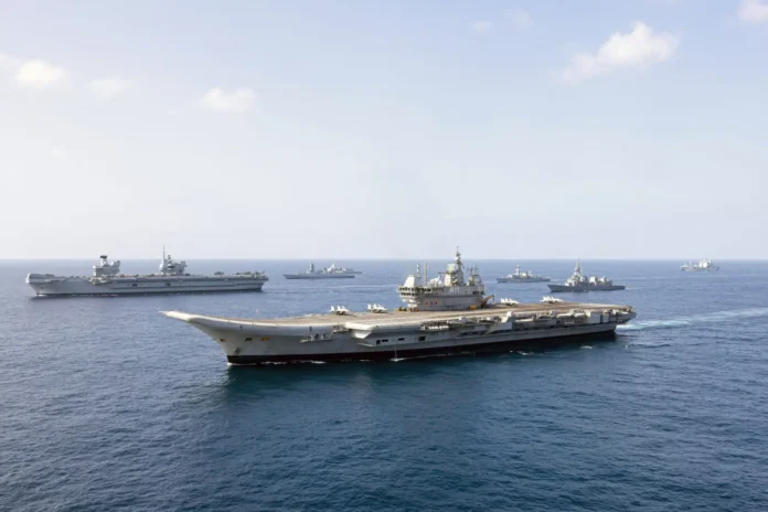 The UK's Carrier Strike Group forms up with the Indian Navy, HMS Prince of Wales (left) and INS Vikrant (front) are joined by other ships of the task group, JS Akebono and Indian Naval Ships.